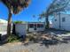 Front view of a light-colored house with a screened porch at 2925 Clinton S St, Gulfport, FL 33707