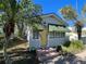 House exterior with yellow door and green awnings at 2925 Clinton S St, Gulfport, FL 33707