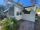 Charming bungalow with awning, a paved patio, and lush landscaping at 2925 Clinton S St, Gulfport, FL 33707