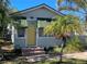 House exterior with yellow door and green awnings at 2925 Clinton S St, Gulfport, FL 33707