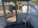 Enclosed porch with white chair and dolphin-shaped door at 2925 Clinton S St, Gulfport, FL 33707