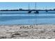 Sandy beach with calm water and sailboats in the distance at 2925 Clinton S St, Gulfport, FL 33707