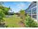 Landscaped backyard with canal and white fence views at 5316 Loon Nest Ct, Apollo Beach, FL 33572