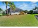 Expansive backyard with canal and tropical landscaping at 5316 Loon Nest Ct, Apollo Beach, FL 33572