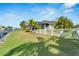 Landscaped backyard with canal view and white fence at 5316 Loon Nest Ct, Apollo Beach, FL 33572