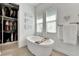 Relaxing bathroom with soaking tub and walk-in closet at 5316 Loon Nest Ct, Apollo Beach, FL 33572