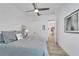 Bright bedroom with a queen bed, ceiling fan, and access to the bathroom at 5316 Loon Nest Ct, Apollo Beach, FL 33572