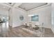 Bright dining room with contemporary chandelier and seating for eight at 5316 Loon Nest Ct, Apollo Beach, FL 33572