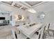 Modern dining room with white table, statement mirror, and art at 5316 Loon Nest Ct, Apollo Beach, FL 33572