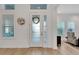 Bright entryway with white door and wood-look floors at 5316 Loon Nest Ct, Apollo Beach, FL 33572