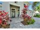 Welcoming front porch with gray pavers and tropical plants at 5316 Loon Nest Ct, Apollo Beach, FL 33572