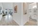 Bright hallway with wood-look floors and views into living and bathroom areas at 5316 Loon Nest Ct, Apollo Beach, FL 33572