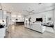 Open concept living room and kitchen with white leather sectional sofa at 5316 Loon Nest Ct, Apollo Beach, FL 33572