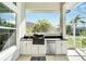 Modern outdoor kitchen with built-in grill and sink at 5316 Loon Nest Ct, Apollo Beach, FL 33572