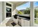 Outdoor kitchen with stainless steel appliances and granite countertops at 5316 Loon Nest Ct, Apollo Beach, FL 33572