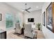 Relaxing sitting area with two armchairs, a TV, and plenty of natural light at 5316 Loon Nest Ct, Apollo Beach, FL 33572