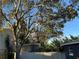 Large backyard with mature trees and a privacy fence at 5703 S Sheridan Rd, Tampa, FL 33611