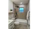 Modern bathroom with a walk-in shower, subway tile and floating shelves at 5703 S Sheridan Rd, Tampa, FL 33611