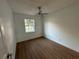 Well-lit bedroom, hardwood floors, and ceiling fan at 5703 S Sheridan Rd, Tampa, FL 33611