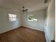 Bright bedroom featuring hardwood floors and ceiling fan at 5703 S Sheridan Rd, Tampa, FL 33611