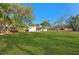Spacious backyard with lush green grass and a detached shed at 5100 3Rd S Ave, St Petersburg, FL 33707