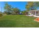 Large grassy backyard with mature trees providing shade at 5100 3Rd S Ave, St Petersburg, FL 33707