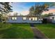 Charming white single-story home with walkway at dusk at 5100 3Rd S Ave, St Petersburg, FL 33707