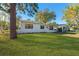 Newly renovated white single story home with black windows and landscaping at 5100 3Rd S Ave, St Petersburg, FL 33707