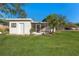 White single story house with a screened porch and well manicured lawn at 5100 3Rd S Ave, St Petersburg, FL 33707