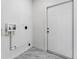 Laundry room with white door and marble tile floor at 5100 3Rd S Ave, St Petersburg, FL 33707