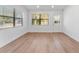 Bright living room featuring wood-look floors and large windows at 5100 3Rd S Ave, St Petersburg, FL 33707