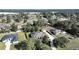 Aerial view of the property showcasing the home, manicured lawn, and surrounding landscape at 11213 Warm Wind Way, Weeki Wachee, FL 34613