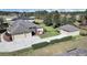 Aerial view of a house showing well-maintained grounds, a three-car garage, and a detached structure at 11213 Warm Wind Way, Weeki Wachee, FL 34613