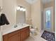 Bright bathroom features modern vanity, neutral color scheme, and a door with access to the outdoors at 11213 Warm Wind Way, Weeki Wachee, FL 34613