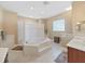 Modern bathroom with large tub, tiled shower, and vanity sink at 11213 Warm Wind Way, Weeki Wachee, FL 34613