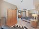 Bedroom with carpet and wood-look floors, ceiling fan, television, and ample closet space at 11213 Warm Wind Way, Weeki Wachee, FL 34613