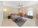 Bedroom with quilt-covered bed, sitting chair, area rug, and neutral walls at 11213 Warm Wind Way, Weeki Wachee, FL 34613