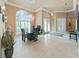 Elegant dining room with a stunning chandelier, large windows, and modern decor at 11213 Warm Wind Way, Weeki Wachee, FL 34613