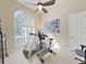 Bright workout room with natural light, ceiling fan, and exercise equipment for a home gym at 11213 Warm Wind Way, Weeki Wachee, FL 34613