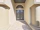 Elegant double front doors with decorative glass details and covered entrance at 11213 Warm Wind Way, Weeki Wachee, FL 34613