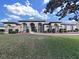 Elegant home featuring arched windows, a manicured lawn, and well-maintained landscaping at 11213 Warm Wind Way, Weeki Wachee, FL 34613