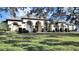 Charming single-story home with a manicured lawn, decorative landscaping, and a welcoming facade at 11213 Warm Wind Way, Weeki Wachee, FL 34613