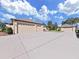 Spacious three-car garage and large driveway providing ample parking space at 11213 Warm Wind Way, Weeki Wachee, FL 34613