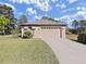 Charming single-Gathering home with a two-car garage and well-maintained lawn at 11213 Warm Wind Way, Weeki Wachee, FL 34613