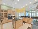 Spacious kitchen featuring custom cabinets, a center island, and modern appliances at 11213 Warm Wind Way, Weeki Wachee, FL 34613