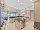 Open-concept kitchen with center island, stainless steel appliances, and plenty of counter space at 11213 Warm Wind Way, Weeki Wachee, FL 34613