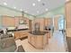 Spacious kitchen with granite countertops, stainless appliances, and a central island with wine storage at 11213 Warm Wind Way, Weeki Wachee, FL 34613