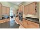 Well-designed kitchen featuring granite countertops and custom wood cabinetry at 11213 Warm Wind Way, Weeki Wachee, FL 34613