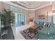 Cozy living room featuring an area rug, comfortable seating, and a sliding glass door to the outdoor patio at 11213 Warm Wind Way, Weeki Wachee, FL 34613