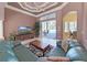 Comfortable living room featuring a ceiling fan, plush couches, and access to the outdoor patio at 11213 Warm Wind Way, Weeki Wachee, FL 34613